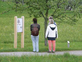 Vor der Tafel zum Obstlehrpfad stehen drei Personen